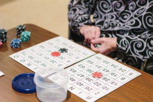 A woman playing bingo at a skilled nursing facility