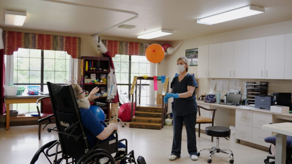 A woman in short term care goes through physical therapy