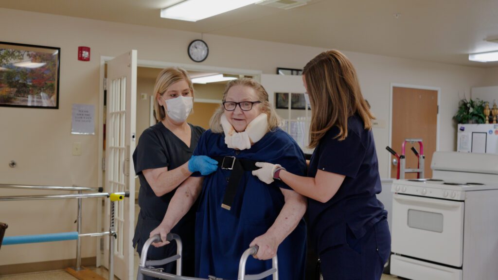 A woman in short term care goes through physical therapy